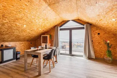 a dining room with a table and a large window at Dona Maria - Tronco da Serra in Campanário