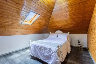 a bedroom with a bed in a wooden ceiling at Dona Maria - Tronco da Serra in Campanário