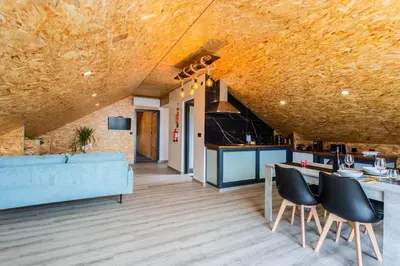 a kitchen and living room with a blue couch at Dona Maria - Tronco da Serra in Campanário