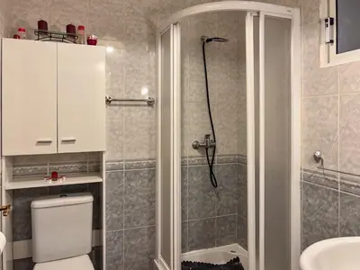 a bathroom with a shower with a toilet and a sink at Casa sol nascente do Caniçal in Caniçal
