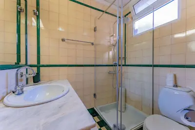 a bathroom with a toilet and a sink and a shower at FLH Funchal Casa do Carvalhal in Funchal