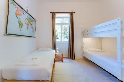 a bedroom with two bunk beds and a window at FLH Funchal Casa do Carvalhal in Funchal