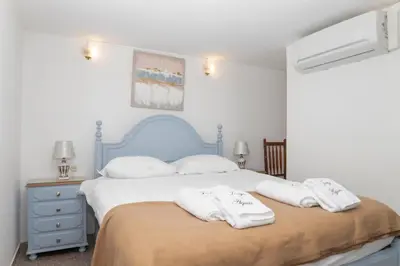 a bedroom with a bed with two towels on it at Apartamentos Jorge Águas - 1Bedroom Private terrace & Sea view in Burgau