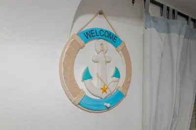 a welcome sign on a wall next to a curtain at Apartamentos Jorge Águas - 1Bedroom Private terrace & Sea view in Burgau
