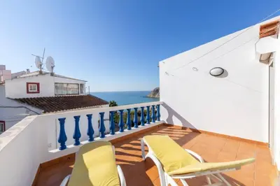 a balcony with chairs and a view of the ocean at Apartamentos Jorge Águas - 1Bedroom Private terrace & Sea view in Burgau