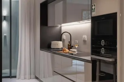 a living room with a couch and a flat screen tv at Luxury Garden Apartment at Savoy Insular in Funchal