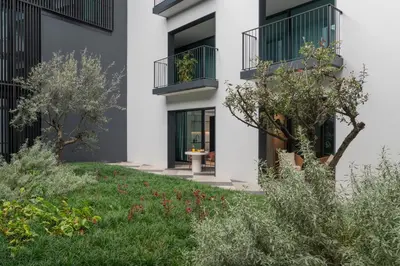 a house with a courtyard with a table and chairs at Luxury Garden Apartment at Savoy Insular in Funchal