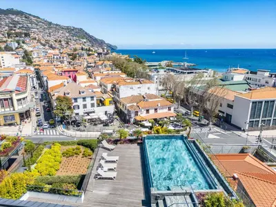 a view of a city with a swimming pool at Luxury Garden Apartment at Savoy Insular in Funchal