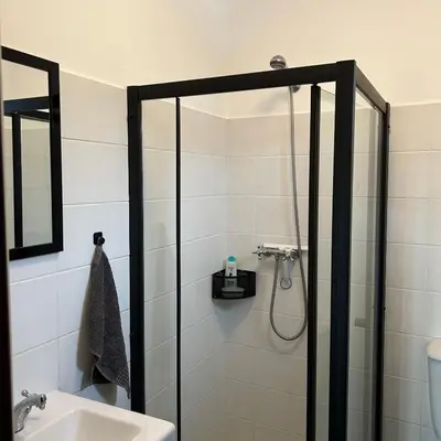 a bathroom with a shower and a sink at As Casinhas da Madeira - Cosy Stone Cottage in a subtropical garden in Arco da Calheta