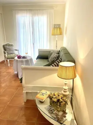 a living room with a couch and a table at Casa da Palmeira Porto Santo in Vila Baleira