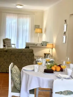 a dining room table with wine glasses and fruit on it at Casa da Palmeira Porto Santo in Vila Baleira