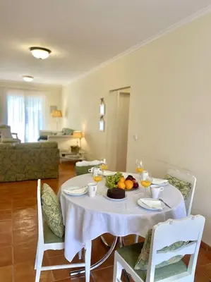 a table with a white table cloth and fruit on it at Casa da Palmeira Porto Santo in Vila Baleira