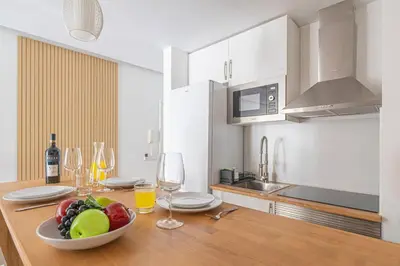 a white bathroom with a toilet and a plant at Pôr do Sol Apartment in Funchal