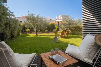 a patio with a table and chairs and an umbrella at Savoy Residence Casa Branca III by An Island Apart in Funchal