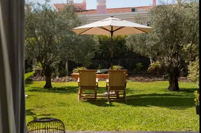 a table and two chairs under an umbrella at Savoy Residence Casa Branca III by An Island Apart in Funchal