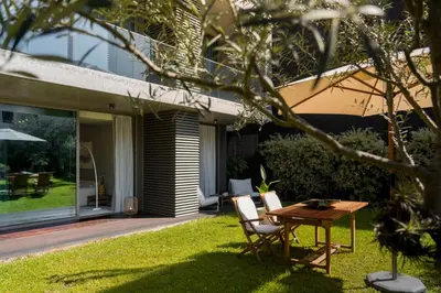 a table and chairs in the yard of a house at Savoy Residence Casa Branca III by An Island Apart in Funchal