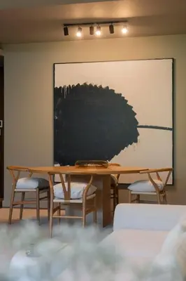 a table with chairs and a painting on the wall at Savoy Residence Casa Branca III by An Island Apart in Funchal