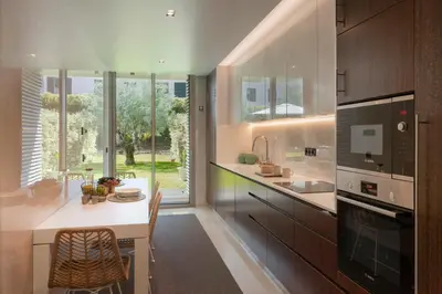 a kitchen with a large window and a table at Savoy Residence Casa Branca III by An Island Apart in Funchal