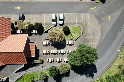 an overhead view of a parking lot with cars and trees at Valley View Hotel Encumeada in Senhora do Rosário
