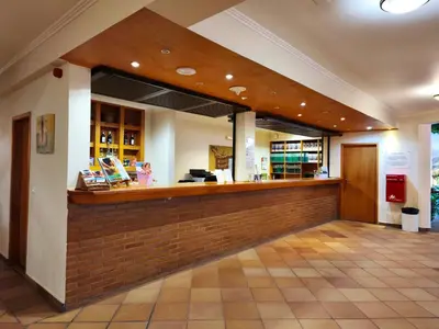 a restaurant with a bar in a building at Valley View Hotel Encumeada in Senhora do Rosário