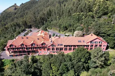 an aerial view of a large building in the mountains at Valley View Hotel Encumeada in Senhora do Rosário