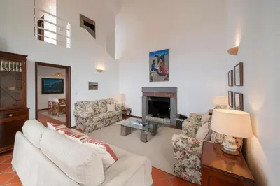 a living room with a couch and a fireplace at Casa Amarela da Fajã da Areia by An Island Apart in São Vicente