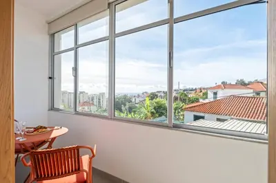 a room with a large window with a table and chair at Tornos in Funchal