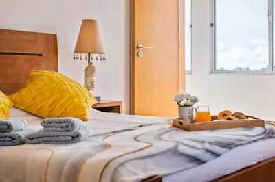 a bedroom with a bed with towels on it at Tornos in Funchal
