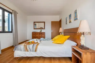 a bedroom with a large bed and a table at Tornos in Funchal