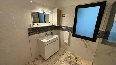 a laundry room with a washing machine and a tv at Quinta do Araújo - GuestHouses in Câmara de Lobos