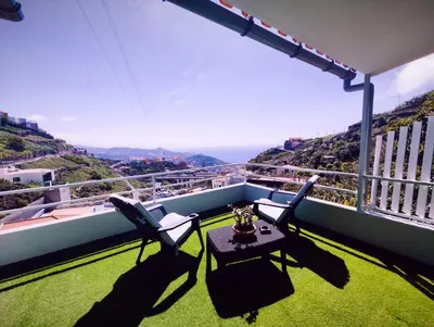 a kitchen and dining room with a table and chairs at Quinta do Araújo - GuestHouses in Câmara de Lobos