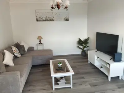 a living room with a couch and a television at Quinta do Araújo - GuestHouses in Câmara de Lobos