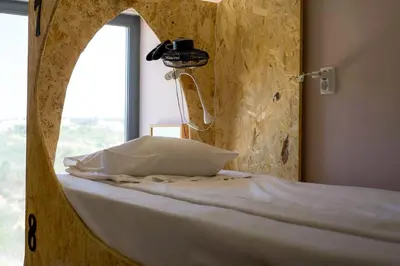 a bed in a room with a window at HI Arrifana Destination Hostel in Aljezur