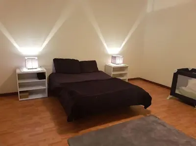 a bedroom with a bed and two night stands at Madeira house garden Villa in Estreito de Câmara de Lobos