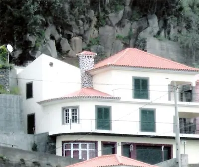a garden with some plants and a rock wall at Madeira house garden Villa in Estreito de Câmara de Lobos