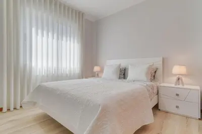a white bedroom with a white bed and a window at Villa Quinta Grande by Holiday rental Madeira in Quinta Grande