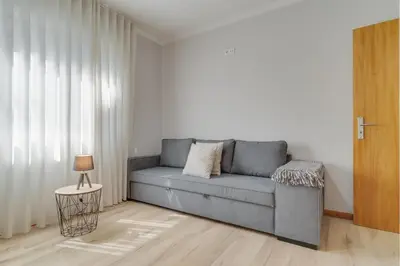 a living room with a gray couch and a table at Villa Quinta Grande by Holiday rental Madeira in Quinta Grande
