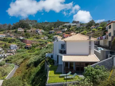a white house on a hill with houses at Villa Quinta Grande by Holiday rental Madeira in Quinta Grande