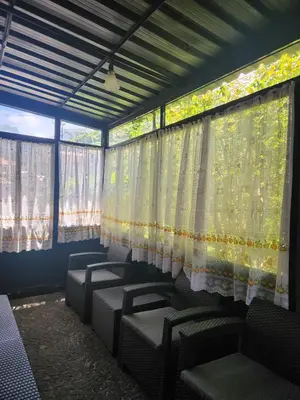 a waiting room with chairs and curtains on the windows at Oscar House Free Parking in São Vicente