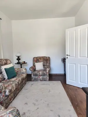 a living room with two chairs and a couch at Oscar House Free Parking in São Vicente