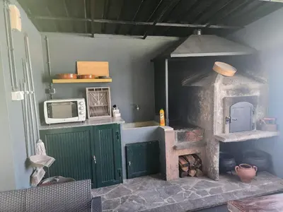 a kitchen with a stove and a microwave at Oscar House Free Parking in São Vicente