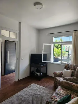 a living room with a couch and a window at Oscar House Free Parking in São Vicente