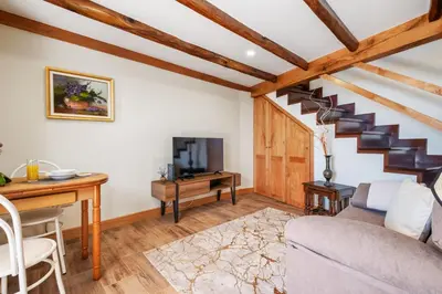 a living room with a couch and a table and a tv at Harmony Retreat by Homie in Ponta do Sol