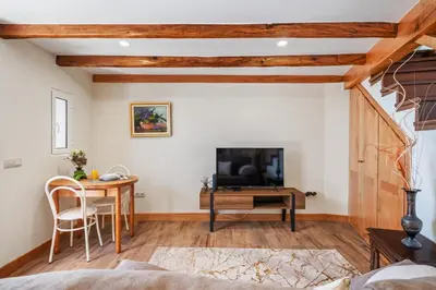 a living room with a television and a table at Harmony Retreat by Homie in Ponta do Sol