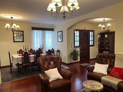 a living room with a table and a dining room at Vale dos Passarinhos in São Vicente