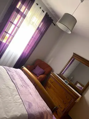 a bedroom with a bed and a mirror and a window at Vale dos Passarinhos in São Vicente