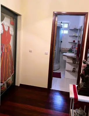 a room with a door with a dress on the wall at Vale dos Passarinhos in São Vicente