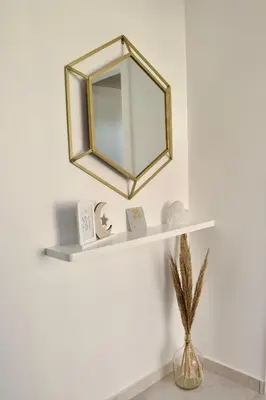 a mirror on a shelf on a wall at Golden Moon, Ponta do Sol in Ponta do Sol