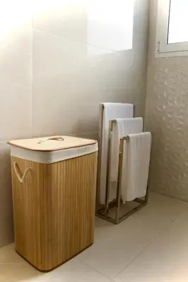 a bathroom with a wooden tub and two towels at Golden Moon, Ponta do Sol in Ponta do Sol