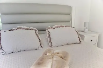 a bedroom with a bed with two pillows at Golden Moon, Ponta do Sol in Ponta do Sol